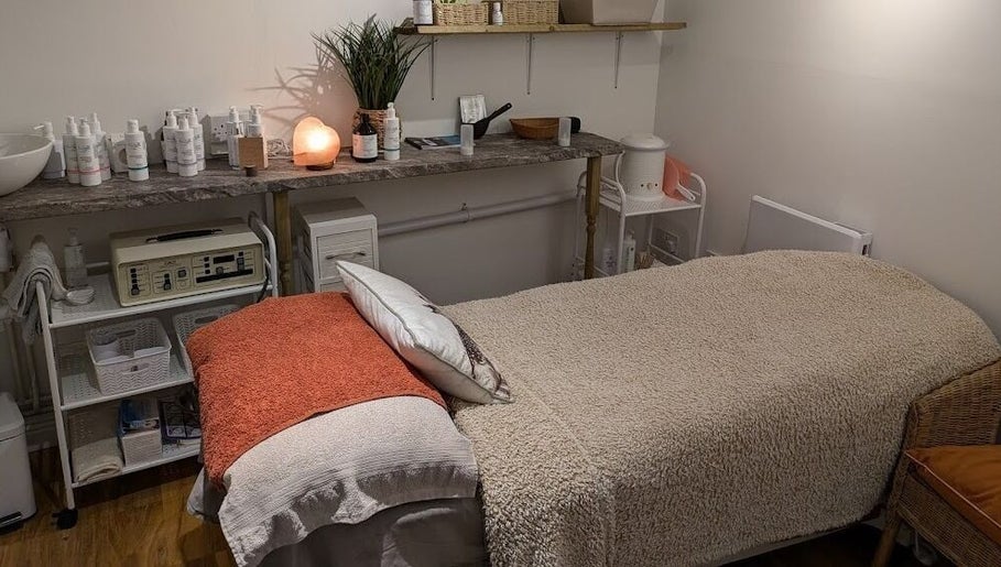 Tranquil treatment room at Nature's Temple Beauty, Sudbury, England, GB, featuring a cozy treatment bed and calming decor.