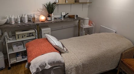 Tranquil treatment room at Nature's Temple Beauty, Sudbury, England, GB, featuring a cozy treatment bed and calming decor.