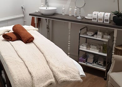 Relaxing treatment room at Nature's Temple Beauty, Sudbury, England, GB featuring a cozy massage bed.