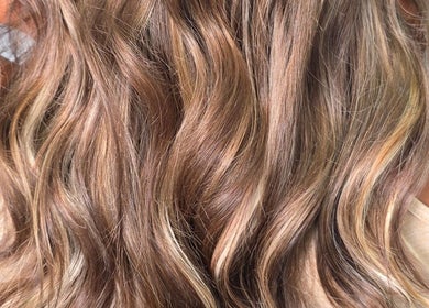 Close-up of lush, wavy hair styled at Kym Bongartz Hair in Edinburgh, Scotland, GB.