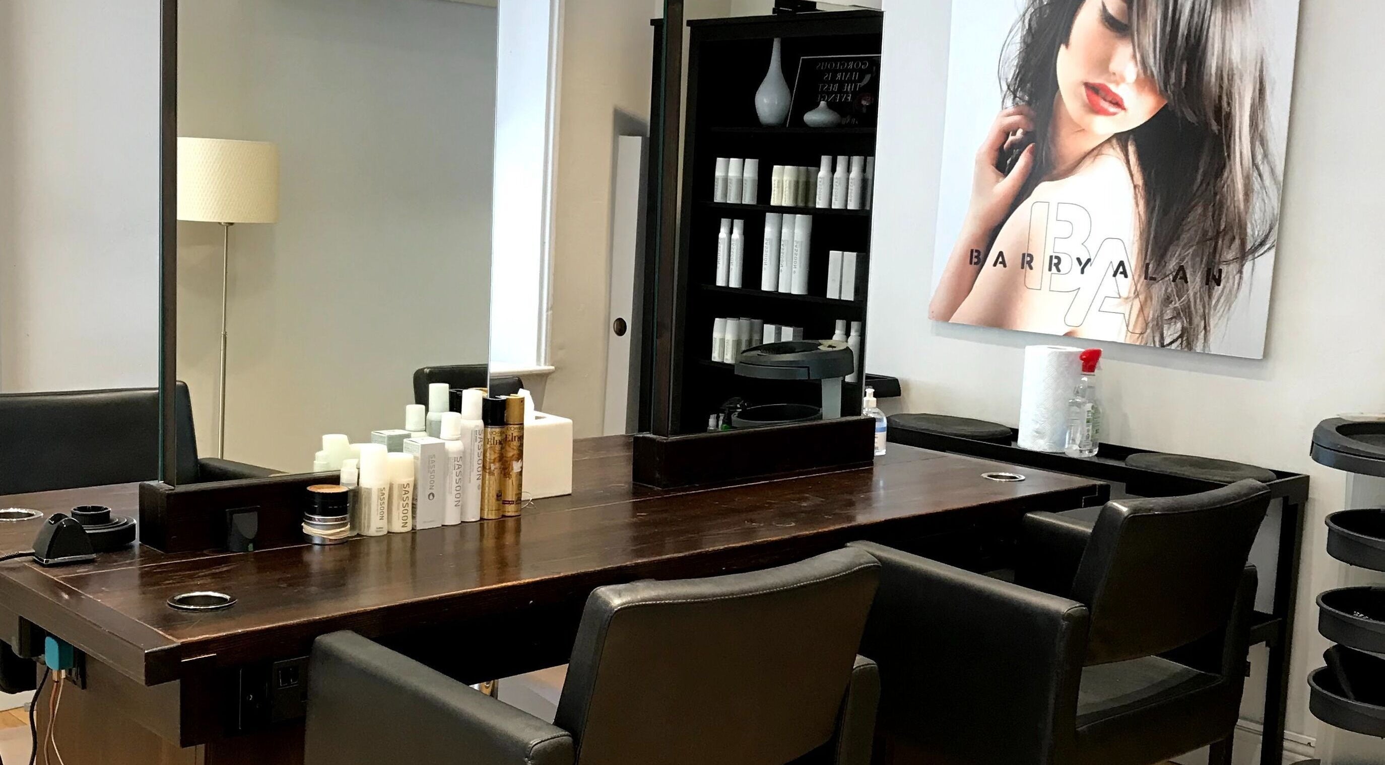 Stylish seating and hair products at Barry Alan Hair Salon, Norwich, England, GB.