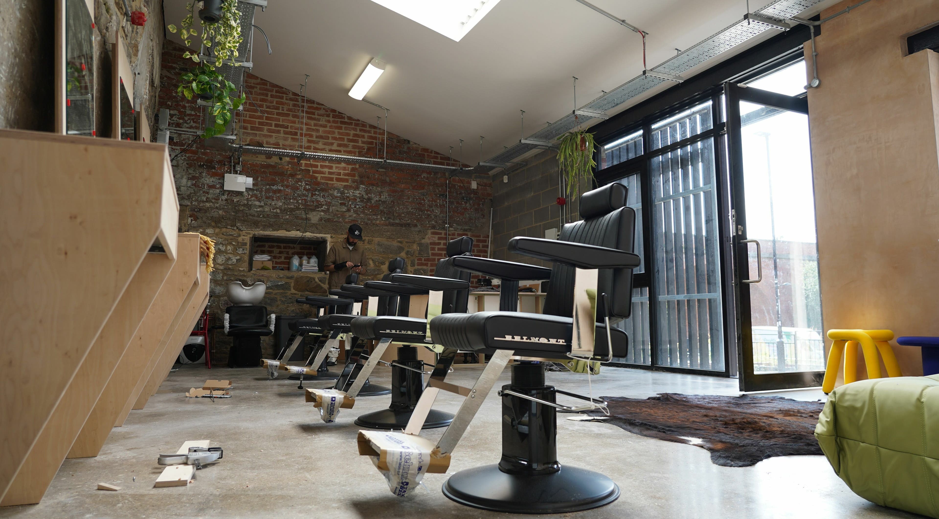 Modern barber chairs at The Hoi Polloi Ouseburn, Newcastle upon Tyne, England, GB, showcasing stylish interior.