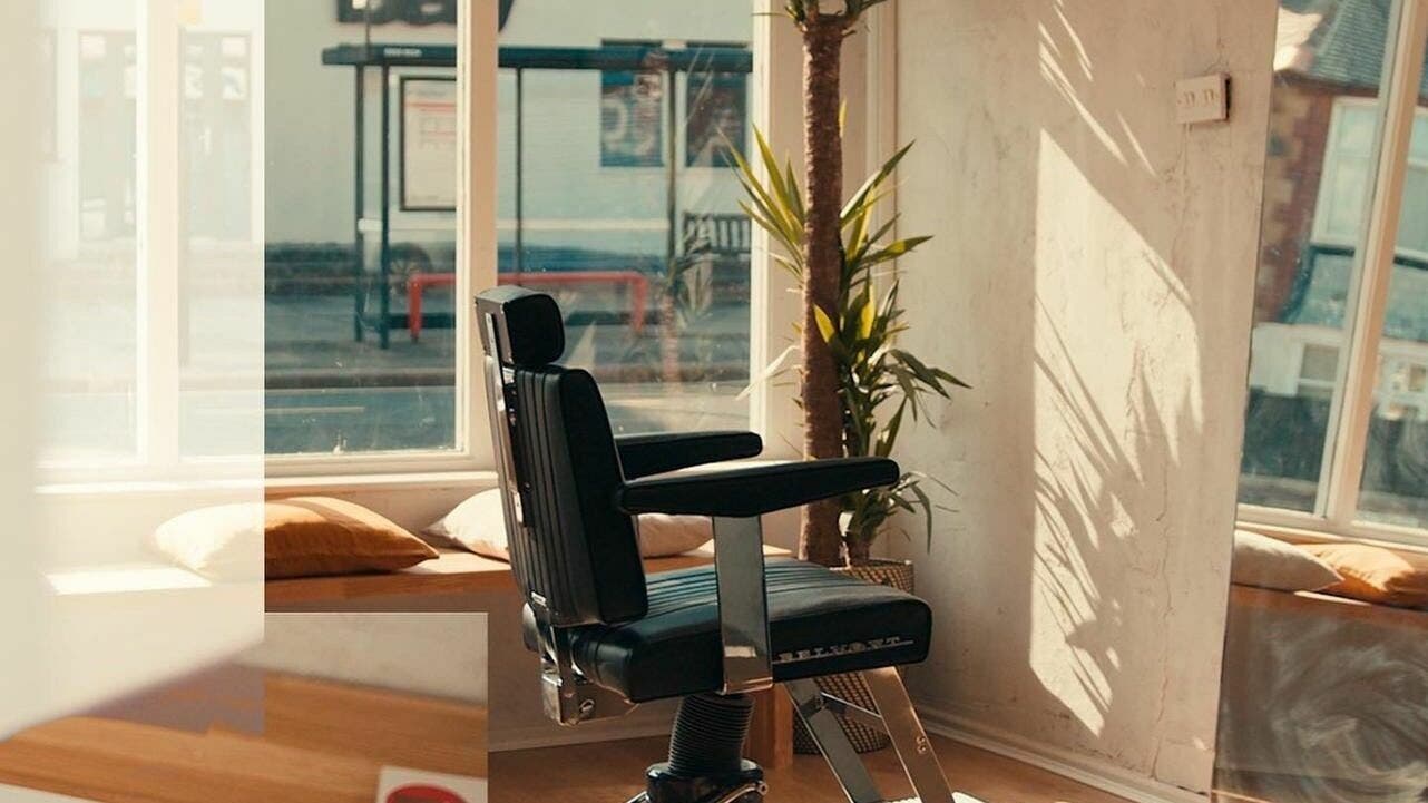 Stylish barber chair at The Hoi Polloi Whitley Bay, Whitley Bay, England, GB with natural lighting.