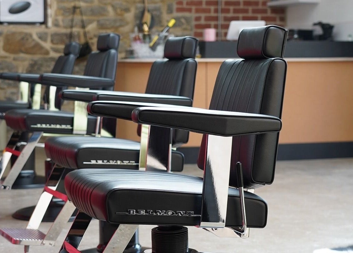 Elegant barber chairs at The Hoi Polloi City Centre, Newcastle upon Tyne, England, GB, showcasing modern design.