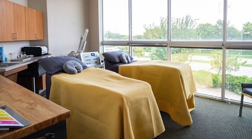 Bright treatment room at Stone International Wellness Center, Plano, Texas, US with two massage beds.