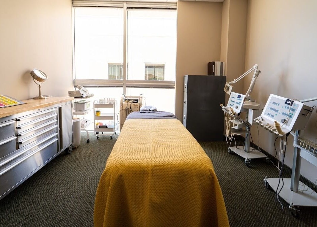 Relaxing treatment room at Stone International Wellness Center, Plano, Texas, US, featuring a massage table and equipment.
