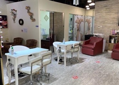 Modern interior of Elle Beauté Ladies Salon in Dubai, AE, featuring stylish chairs and sleek design.