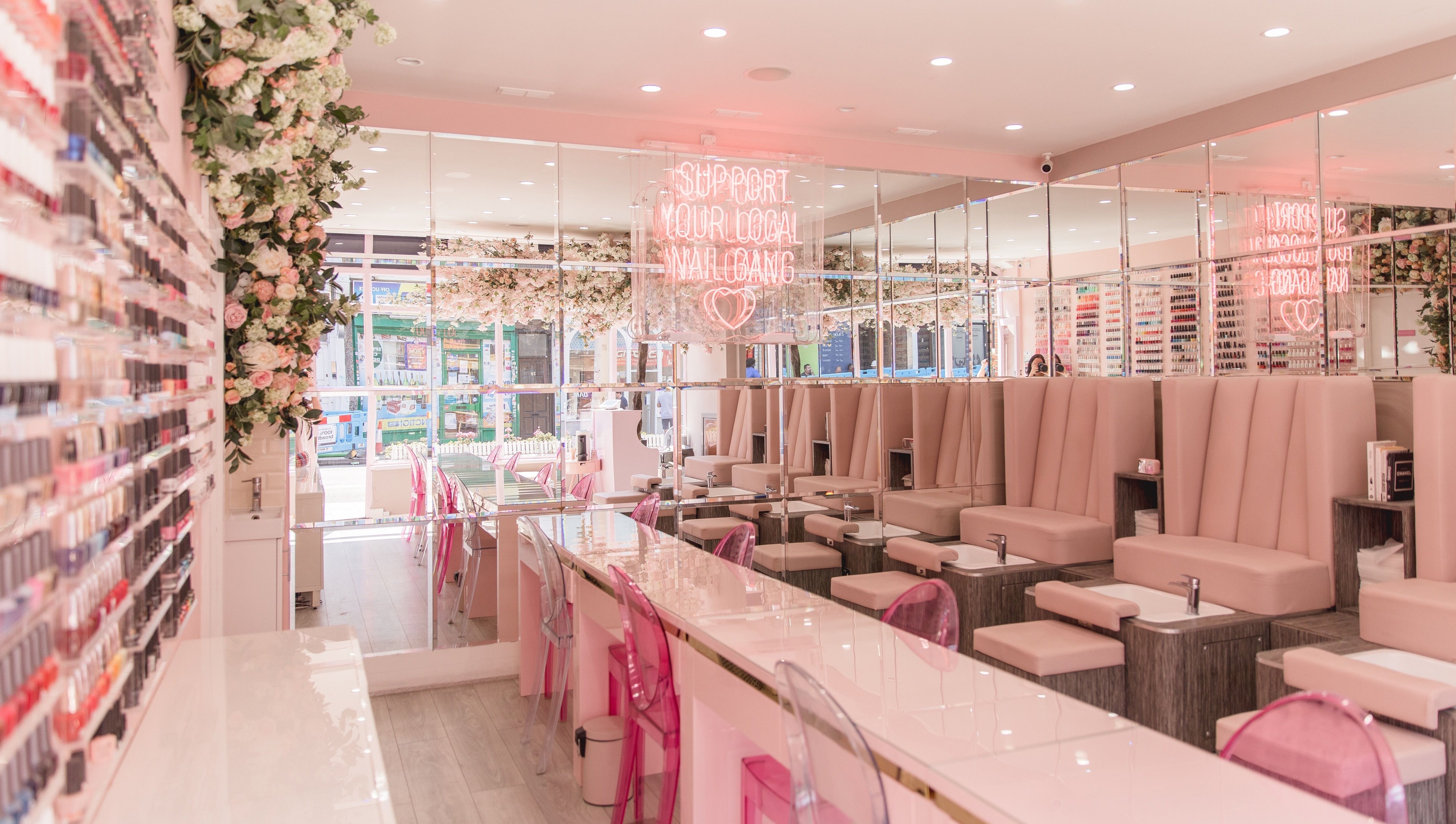 Modern, elegant salon interior at Nail'd It Clapham in London, England, GB with plush seating and vibrant decor.