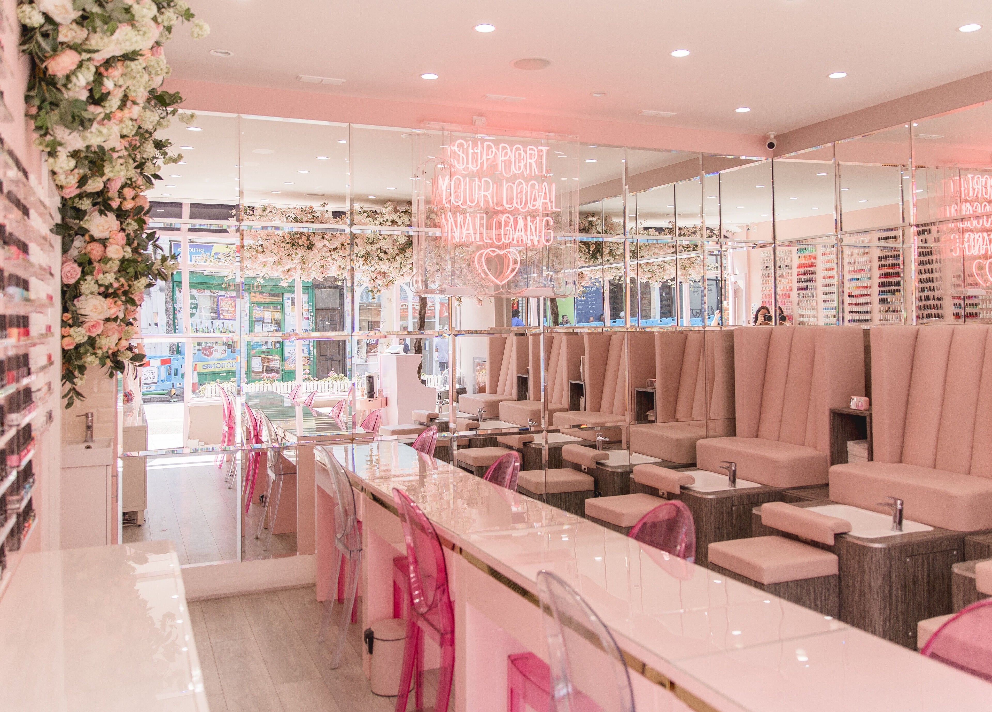 Modern, elegant salon interior at Nail'd It Clapham in London, England, GB with plush seating and vibrant decor.