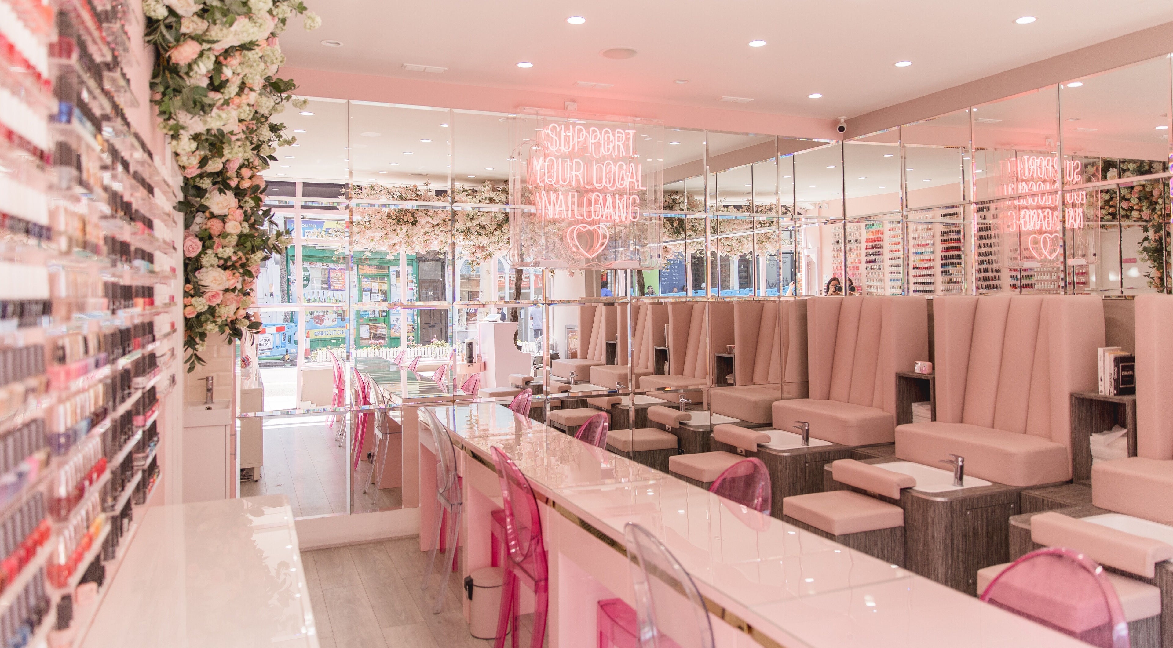 Modern, elegant salon interior at Nail'd It Clapham in London, England, GB with plush seating and vibrant decor.