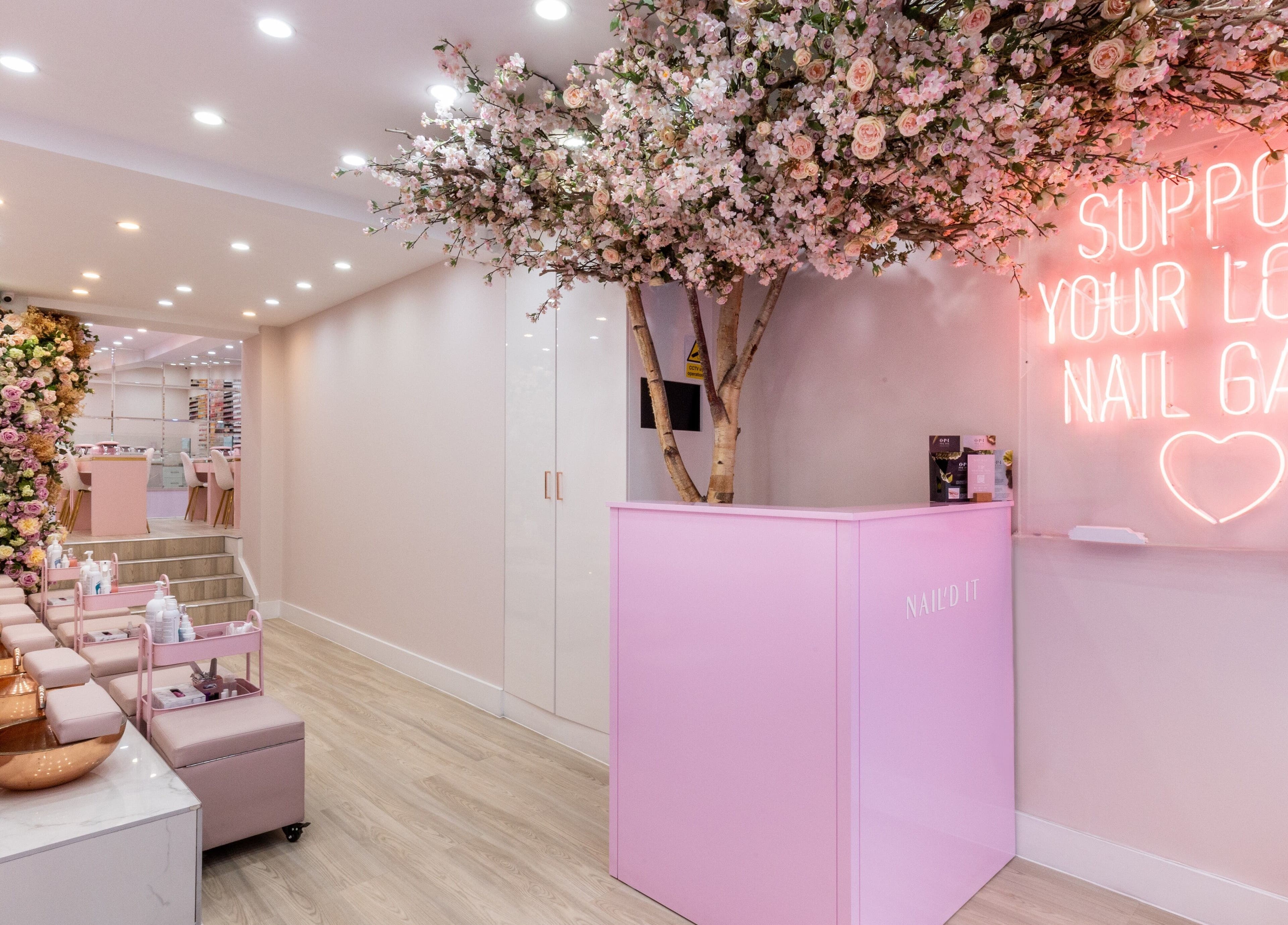 Elegant floral-themed interior of Nail'd It Marylebone in London, England with chic pink decor.