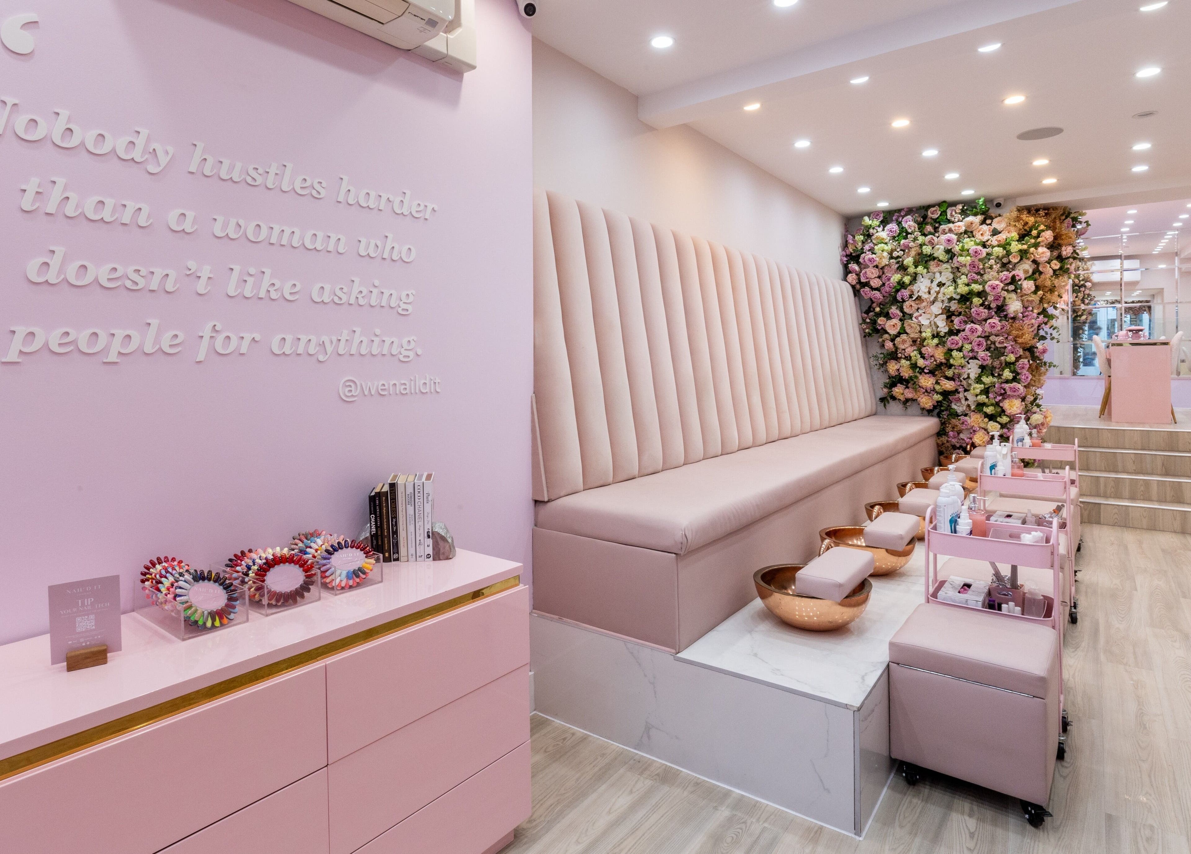 Interior of Nail'd It Marylebone in London, England, GB with chic decor and floral arrangements.