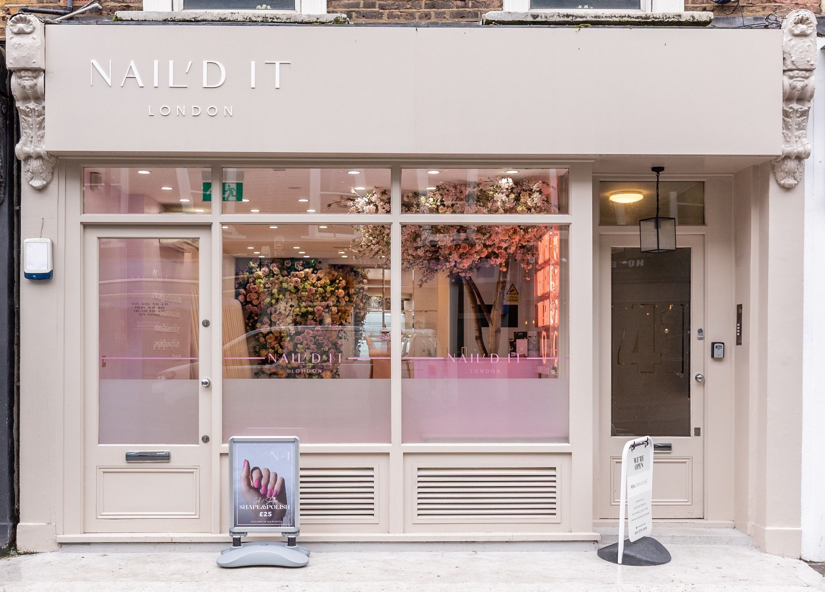 Exterior of Nail'd It Marylebone salon in London, England, GB, featuring elegant decorations and signage.