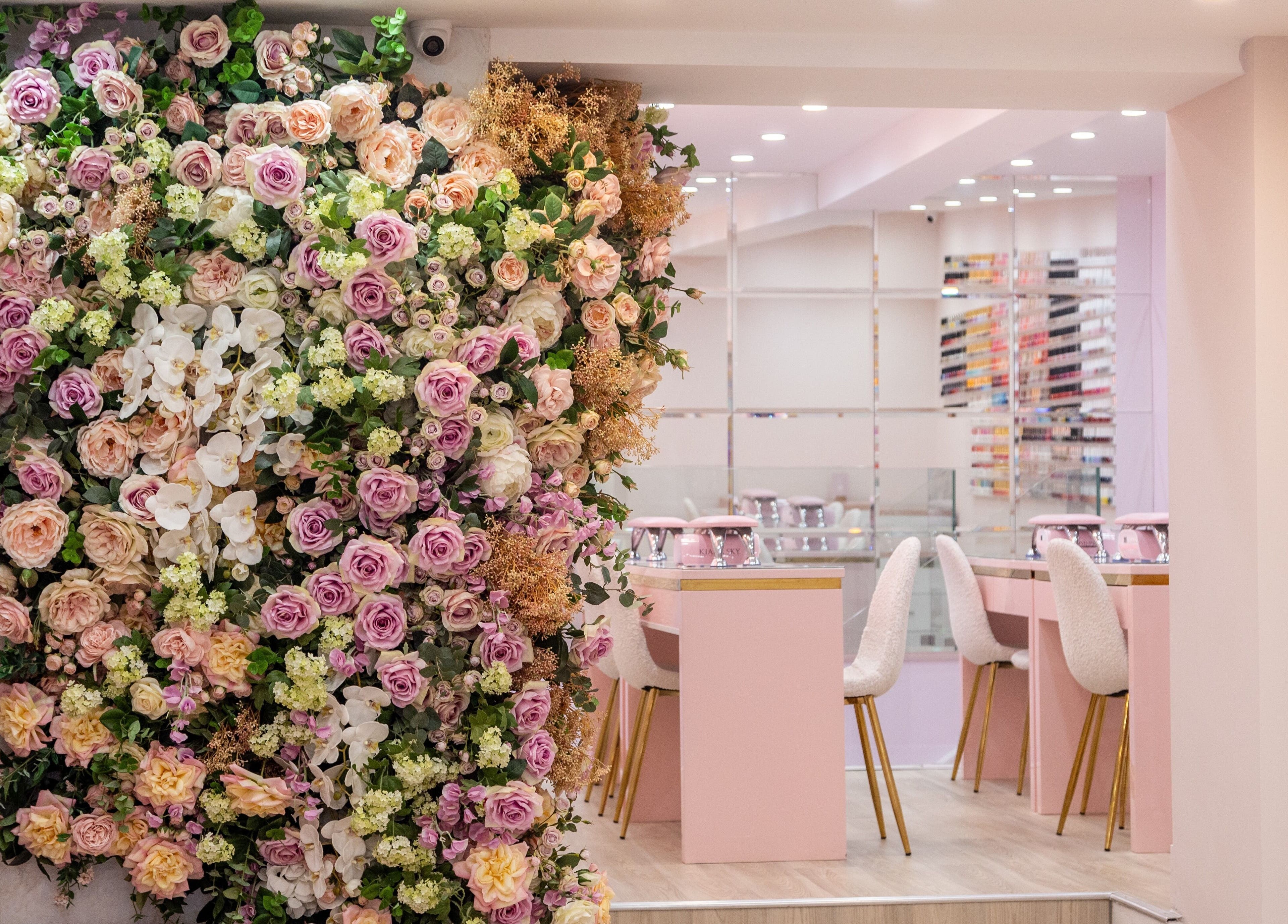 Lush floral wall and chic nail station at Nail'd It Marylebone, London, England, GB.