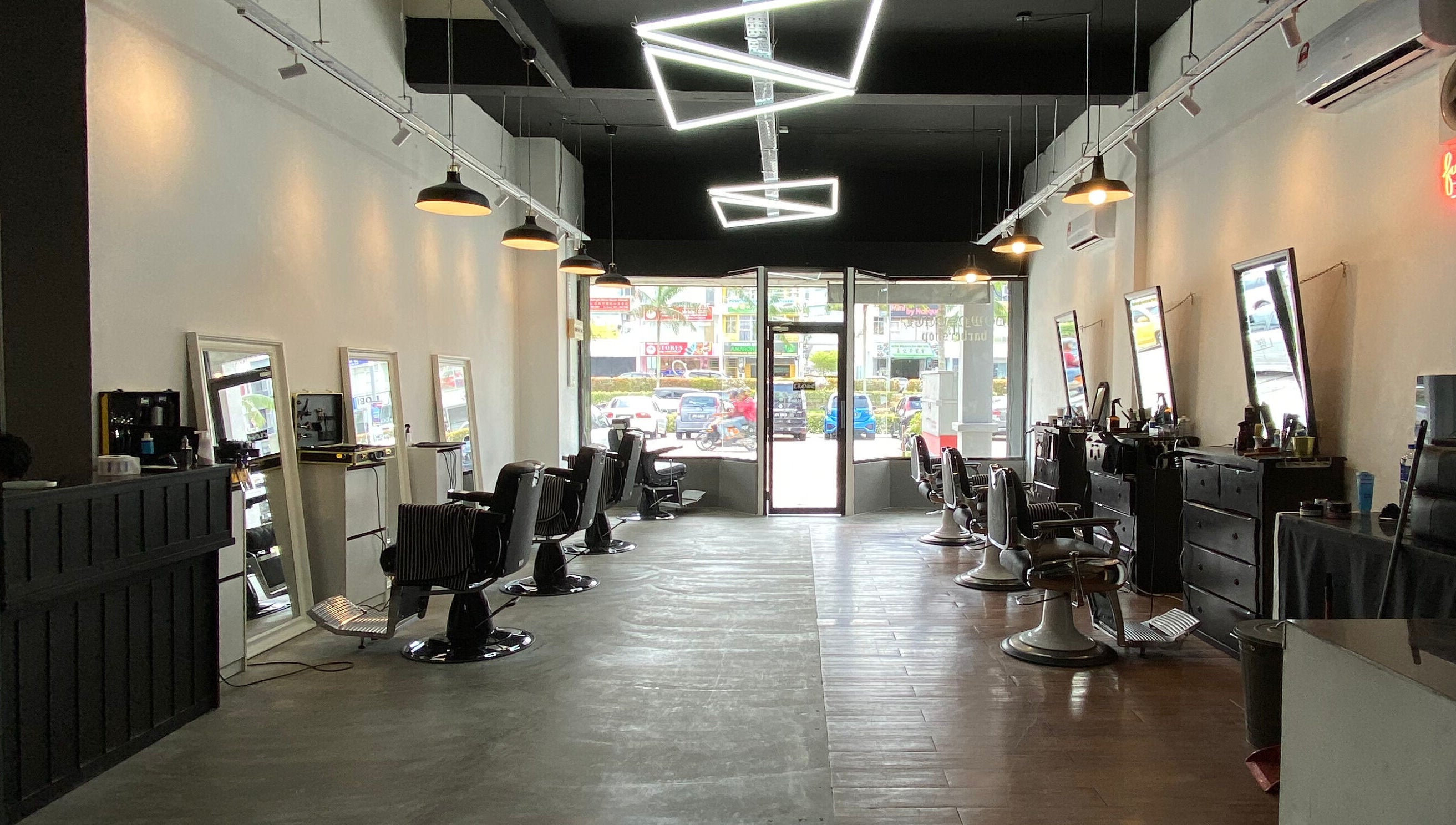 Interior of Downsouth Barbershop Setia Tropika, Johor Bahru, Johor, MY showing stylish chairs and mirrors.
