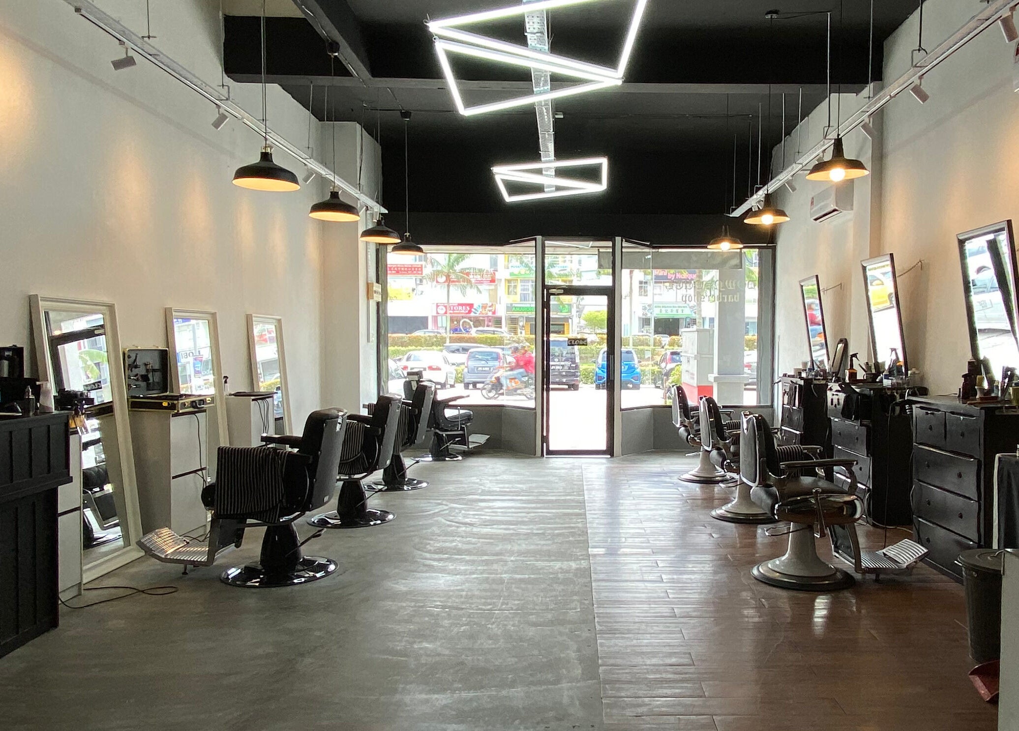 Interior of Downsouth Barbershop Setia Tropika, Johor Bahru, Johor, MY showing stylish chairs and mirrors.