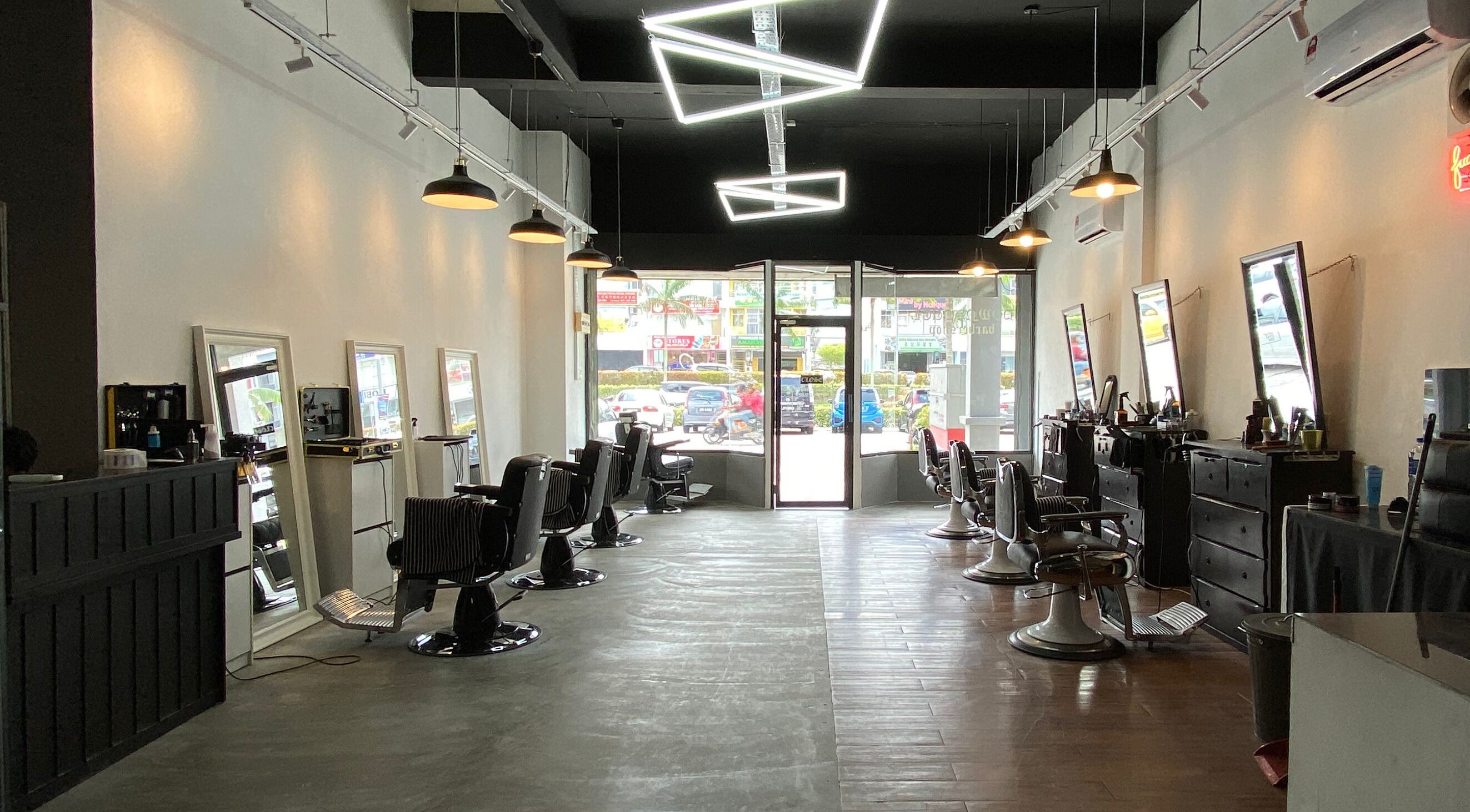 Interior of Downsouth Barbershop Setia Tropika, Johor Bahru, Johor, MY showing stylish chairs and mirrors.