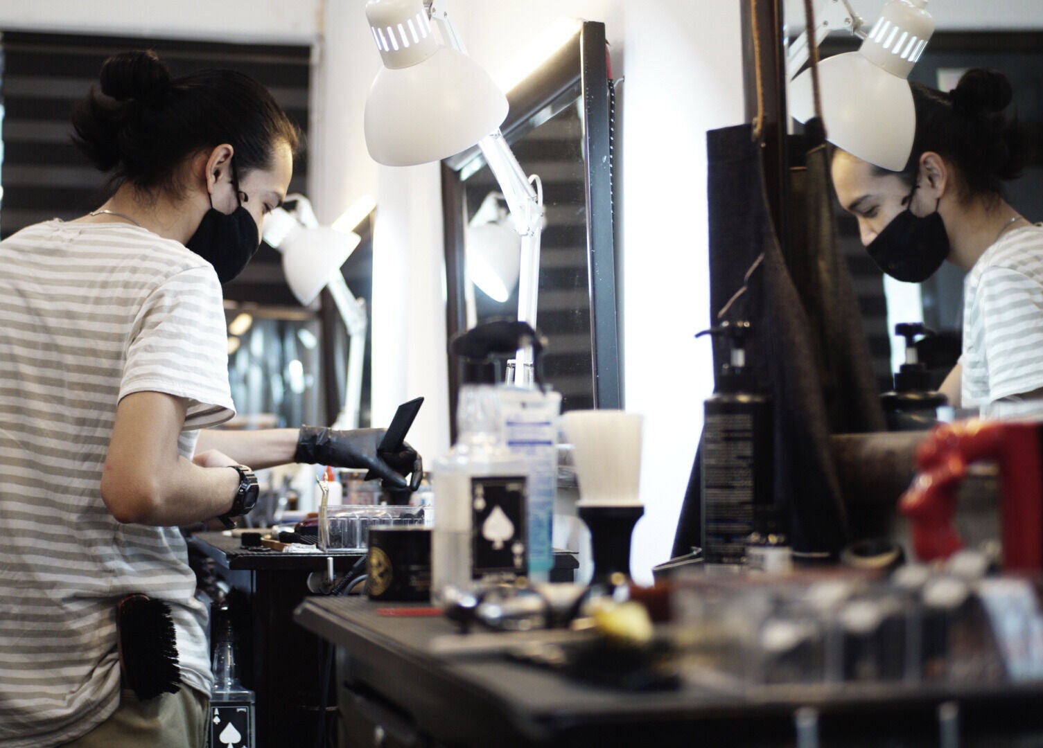 Barber styling hair at Downsouth Barbershop Setia Tropika, Johor Bahru, Johor, MY, with tools in focus.
