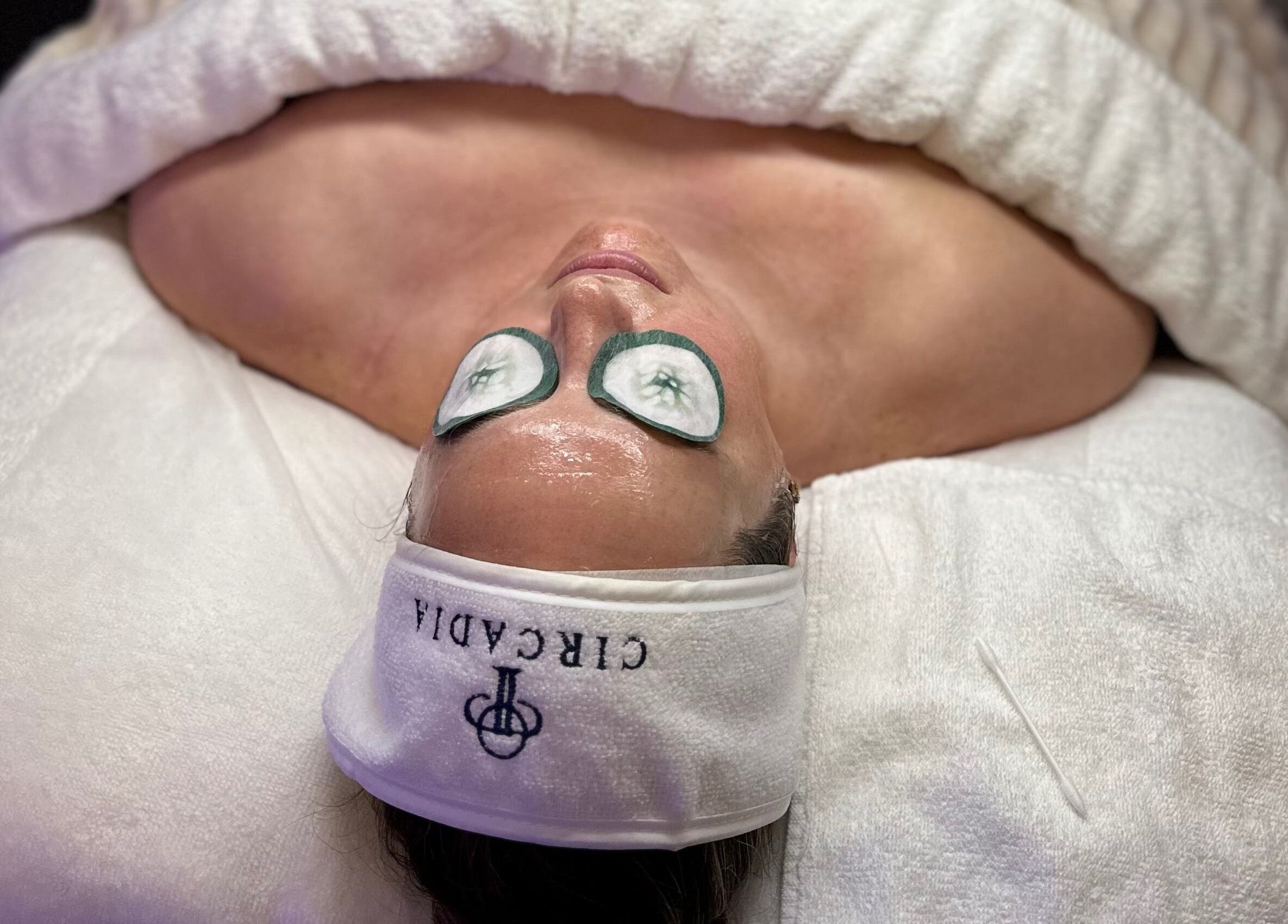 Relaxed client with cucumber eye treatment at Bella Perfection Salon, Eglinton, Western Australia, AU.