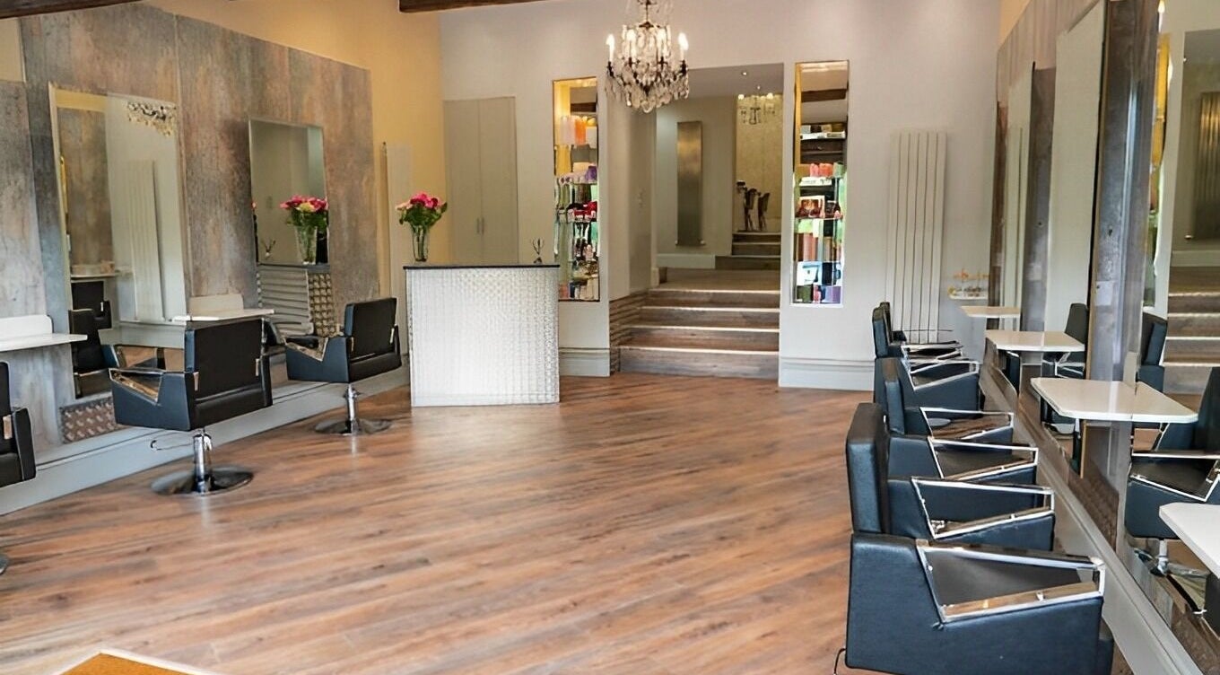 Stylish interior of Holly Blackburn Hair, Wakefield, England, GB, featuring modern styling chairs and mirrors.