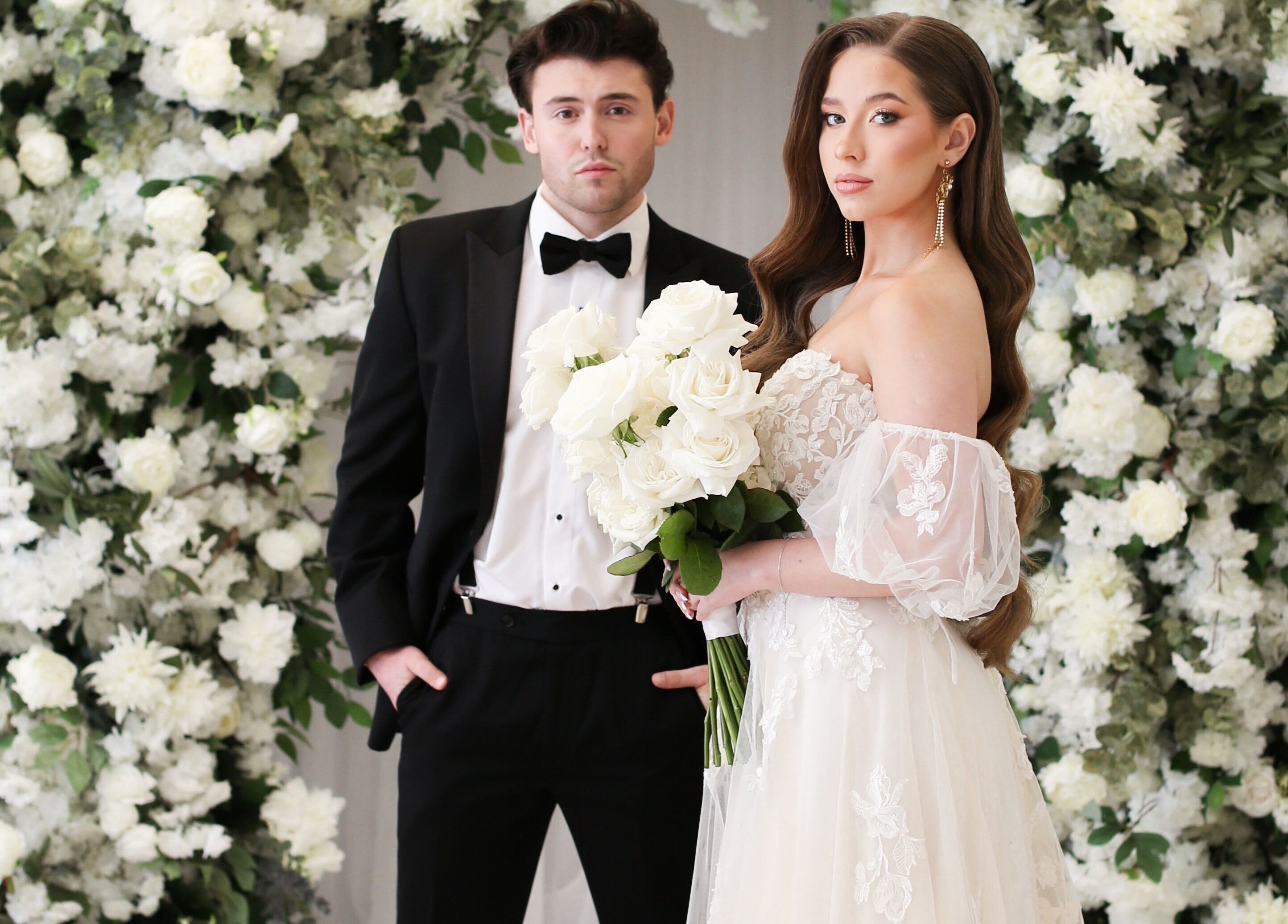 Bride and groom with floral backdrop at Glam me up Toronto in Vaughan, Ontario, CA.