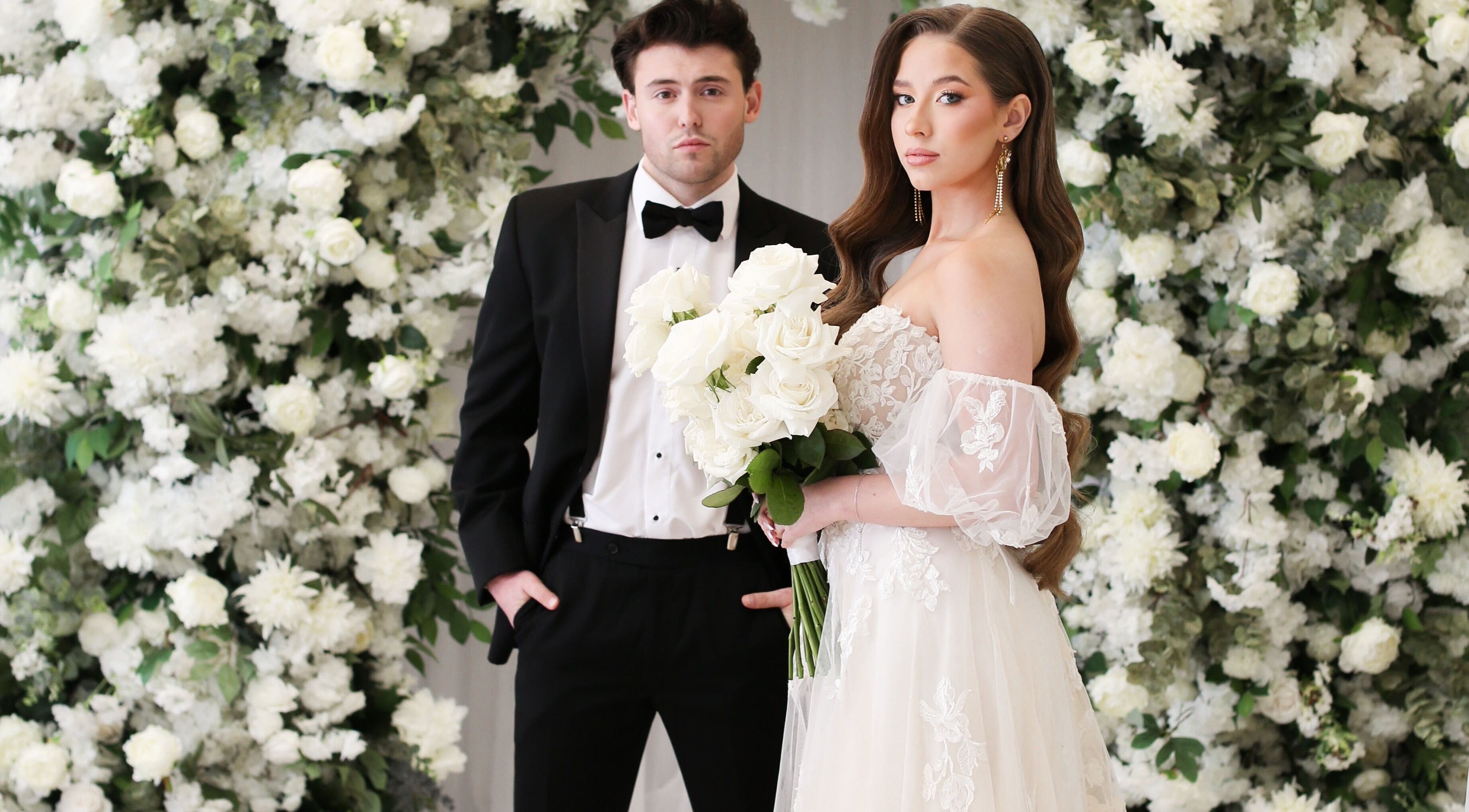 Bride and groom with floral backdrop at Glam me up Toronto in Vaughan, Ontario, CA.