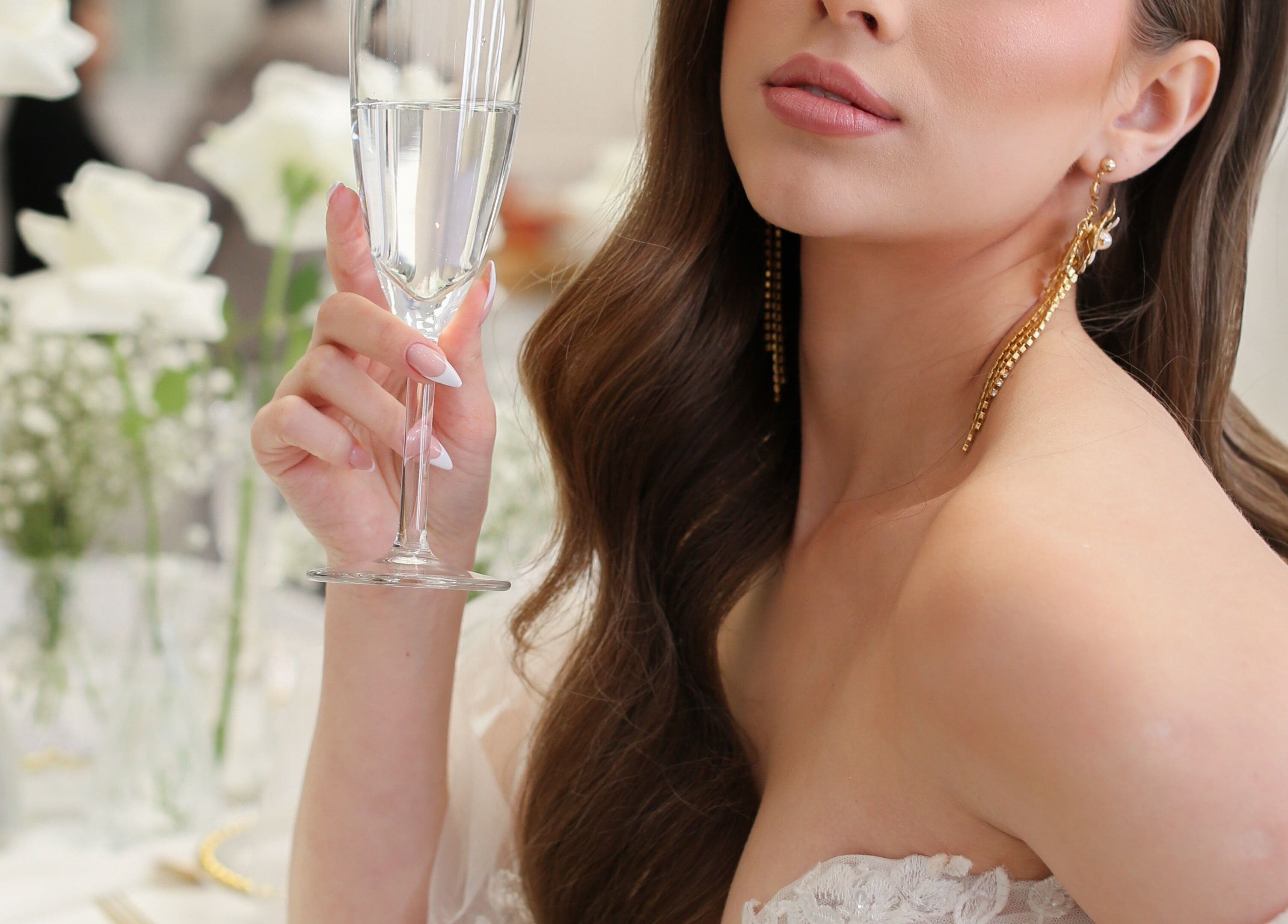 Woman enjoying champagne in elegant setting at Glam me up Toronto, Vaughan, Ontario, CA.