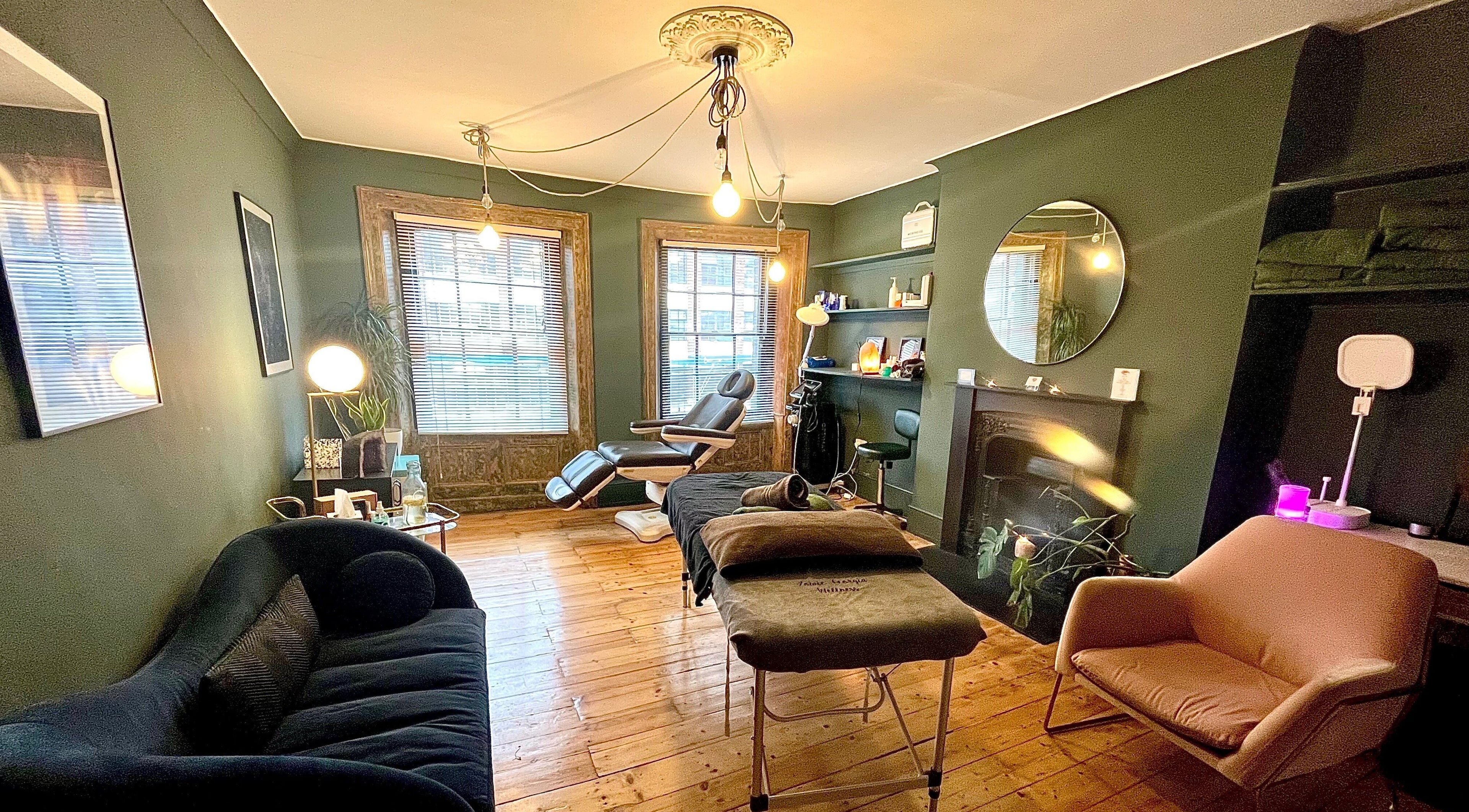 Relaxing treatment room at Zowie Georgia Wellness, London, England, GB with comfy chairs and ambient lighting.