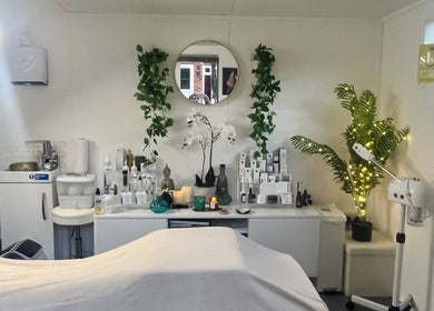 Relaxing treatment room at Precisions Skin Clinic, Leighton Buzzard, England, with serene decor and skincare products.