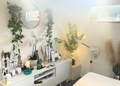 Cozy treatment room at Precisions Skin Clinic, Leighton Buzzard, England, GB with beauty products and soothing plants.