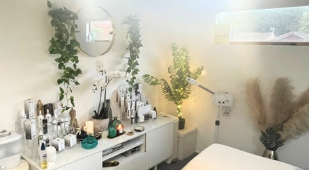 Cozy treatment room at Precisions Skin Clinic, Leighton Buzzard, England, GB with beauty products and soothing plants.