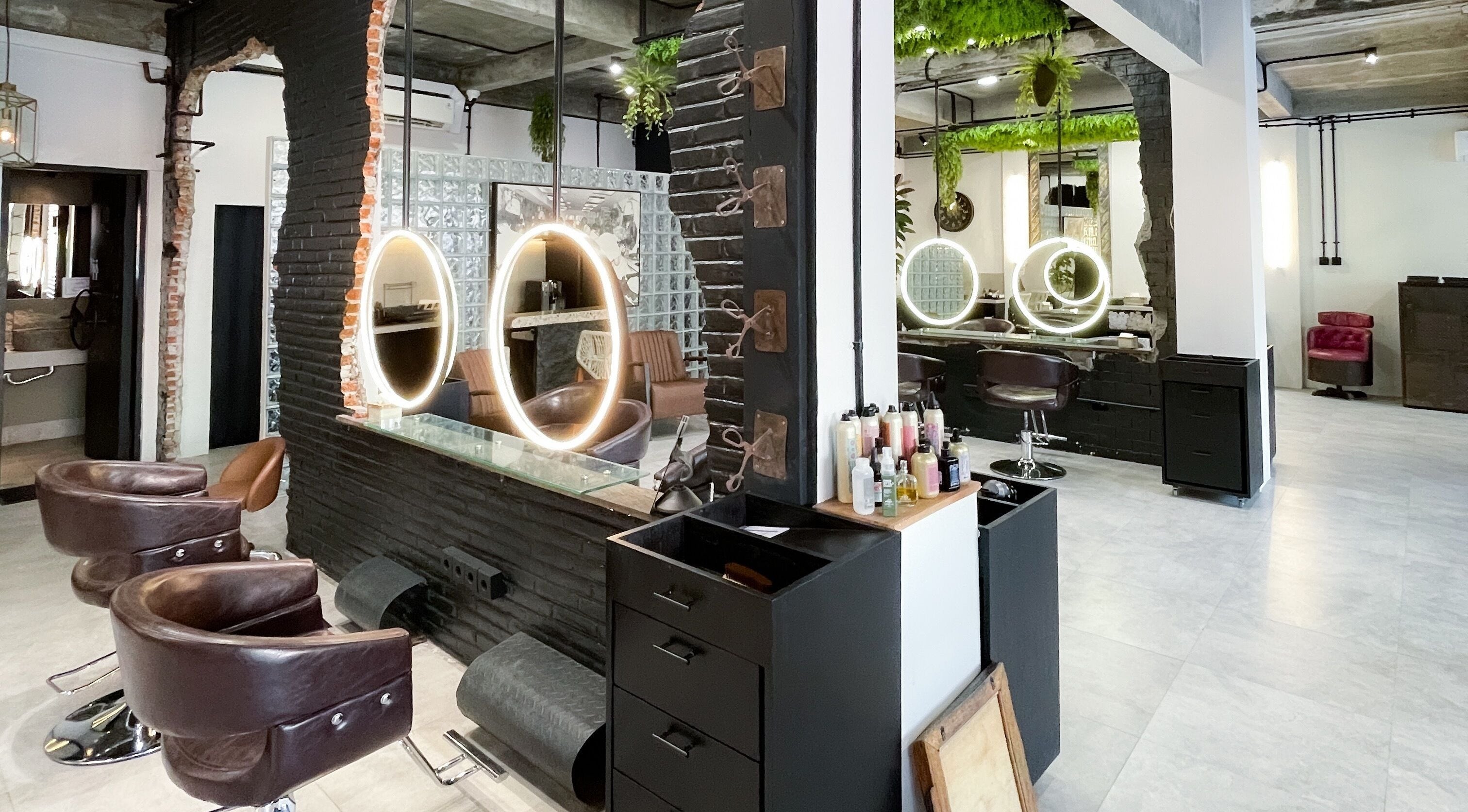 Interior of The Gardezan salon with modern chairs and illuminated mirrors in Bali, Bali, ID.