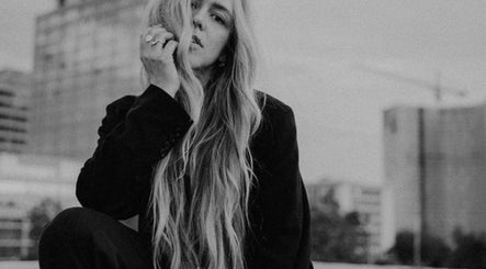 Stylish individual with long hair at SO Natural Extensions, Epsom, England, GB showcasing urban elegance.