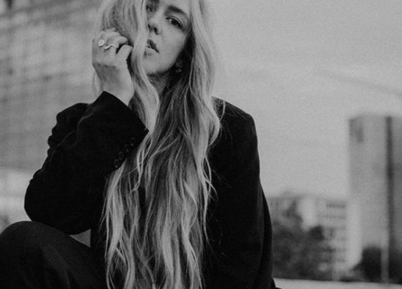 Long-haired woman in urban setting at SO Natural Extensions, Epsom, England, GB.