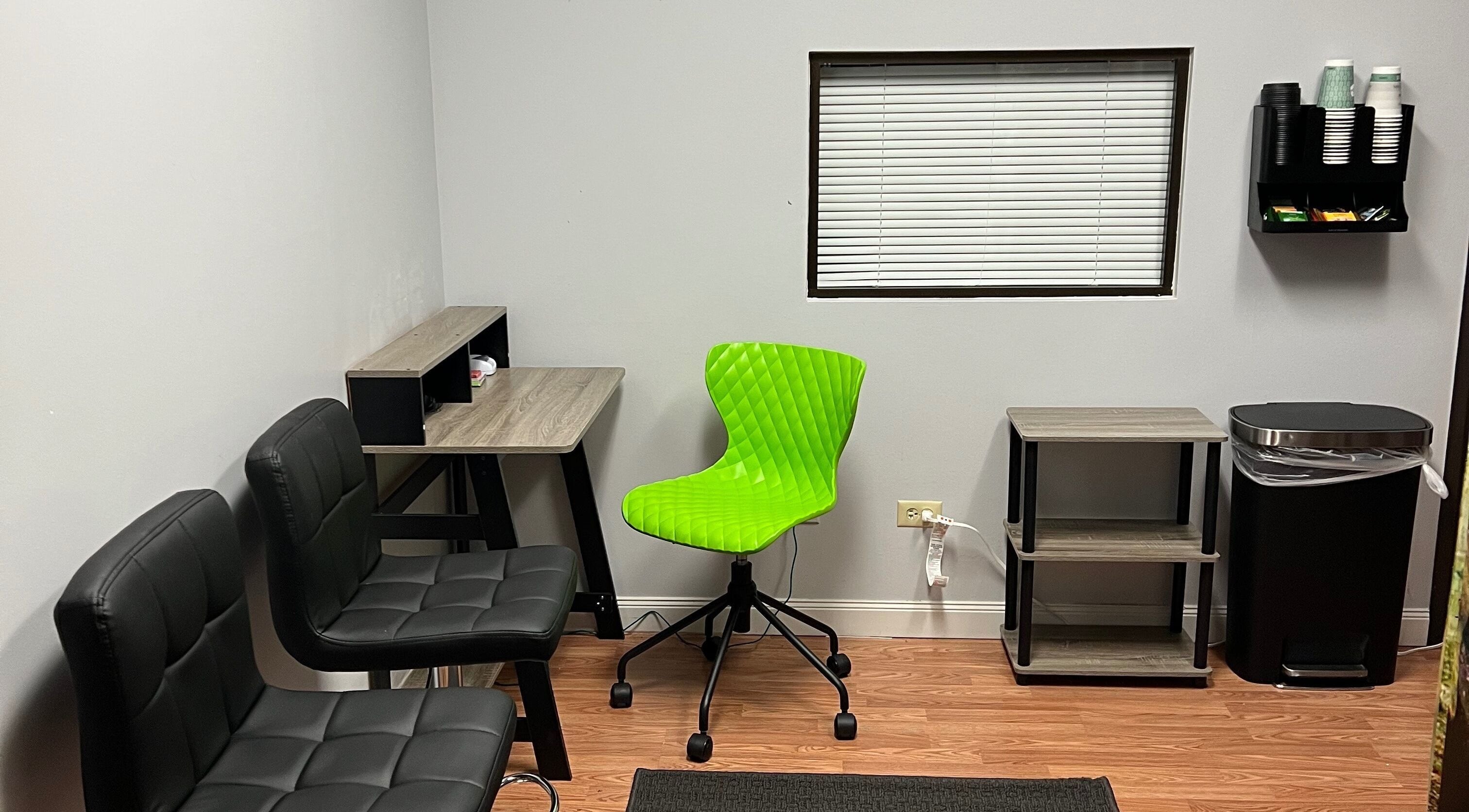 Bright waiting area at Miracle World International, Denver, Colorado, US with green chair and modern decor.