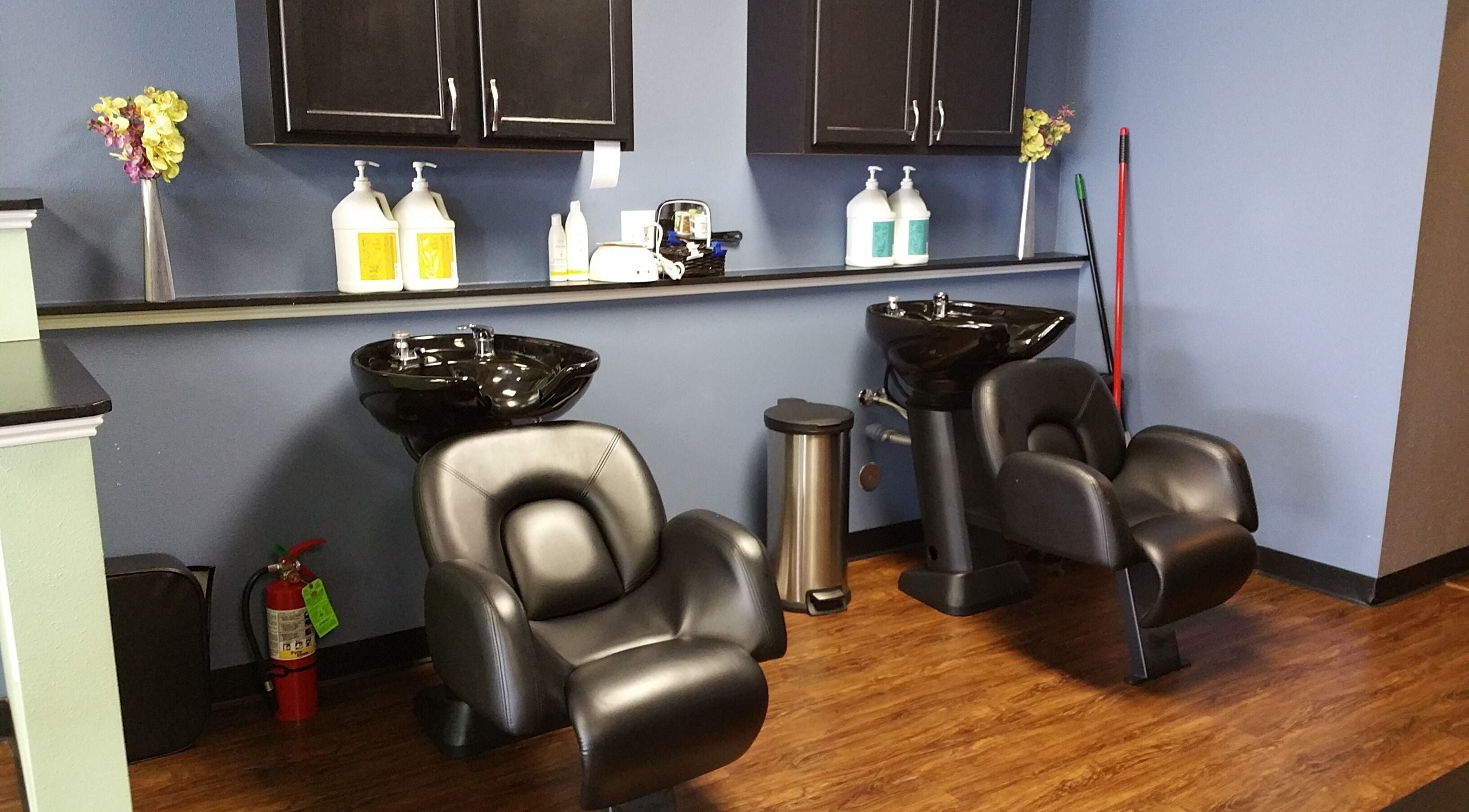Modern hair wash stations at Genesis Salon and Spa, Boscobel, Wisconsin, US, featuring sleek black chairs.