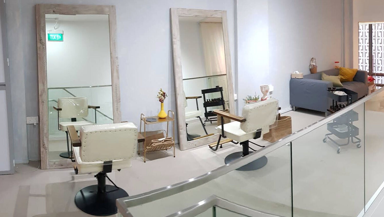 Elegant salon setup at Dogether, Singapore, SG featuring large mirrors and plush seating.