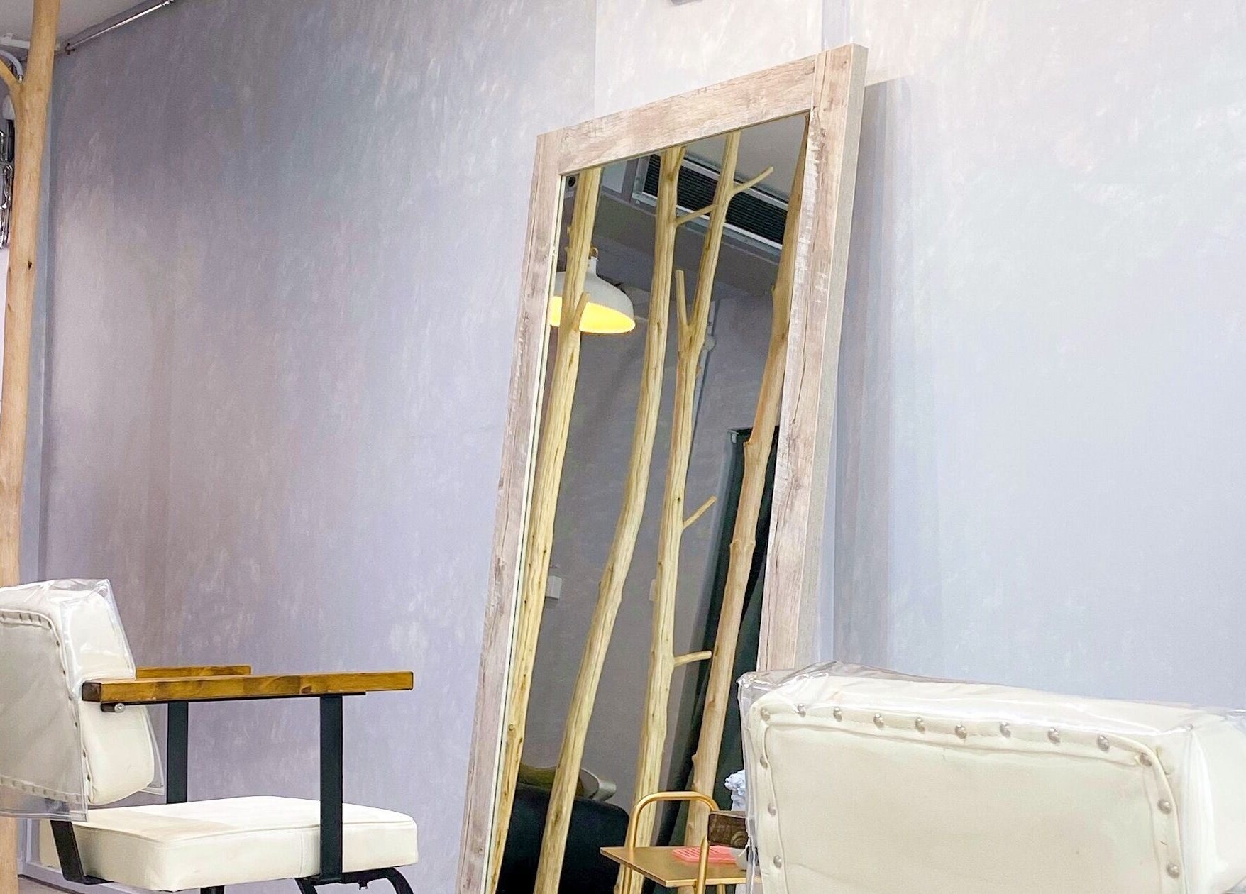 Chic beauty salon interior at Dogether, Singapore, Singapore, SG with rustic mirror and chair.