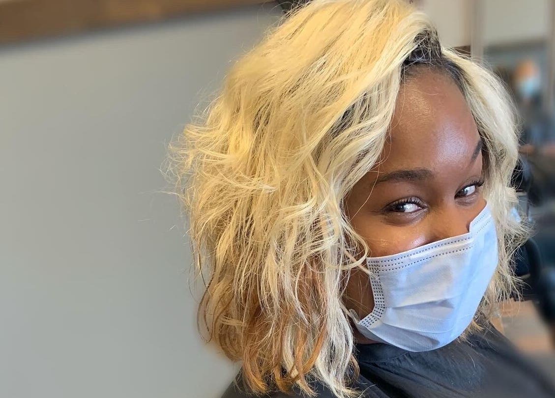 Smiling customer with styled hair at Pressed Unlimited in Jacksonville, Florida, US.