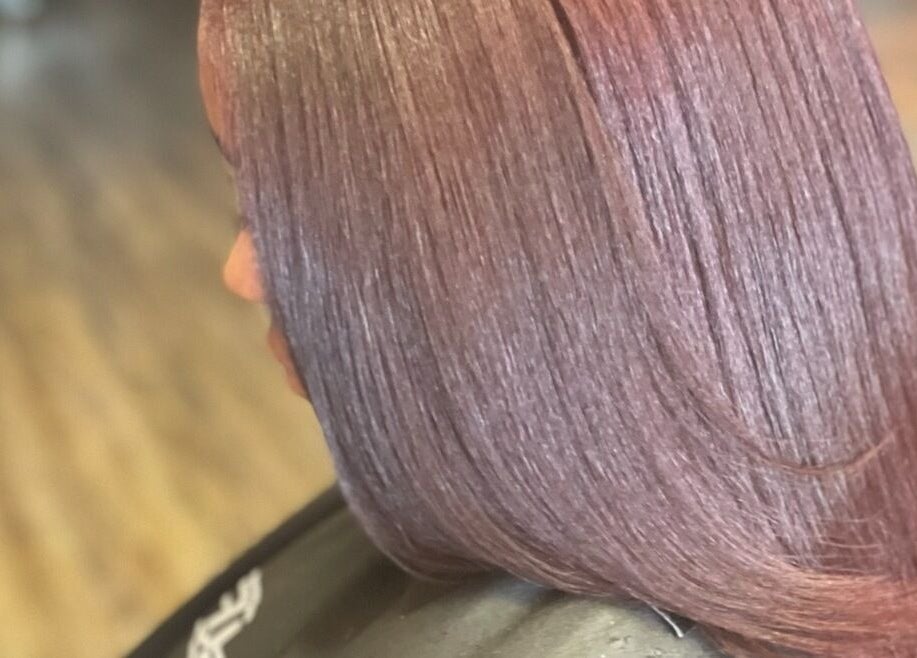 Sleek plum-colored hair styled at Pressed Unlimited in Jacksonville, Florida, US.