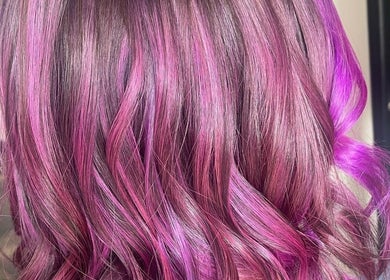 Vibrant magenta hair styled in waves at H & Co, Pontefract, England, GB.
