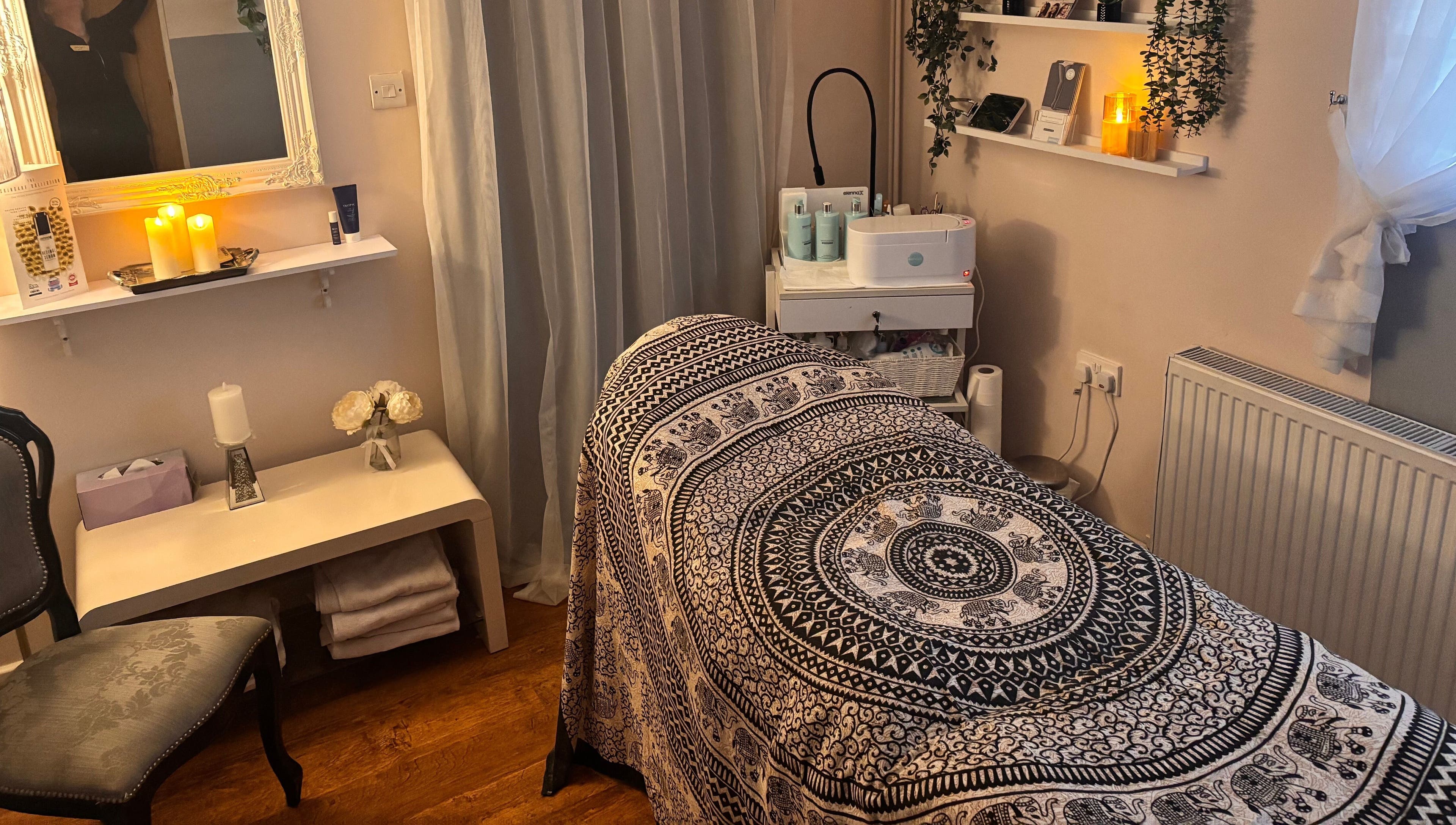 Relaxing treatment room at Elegance Beauty, Osmaston, England, GB with ambient lighting and soothing decor.