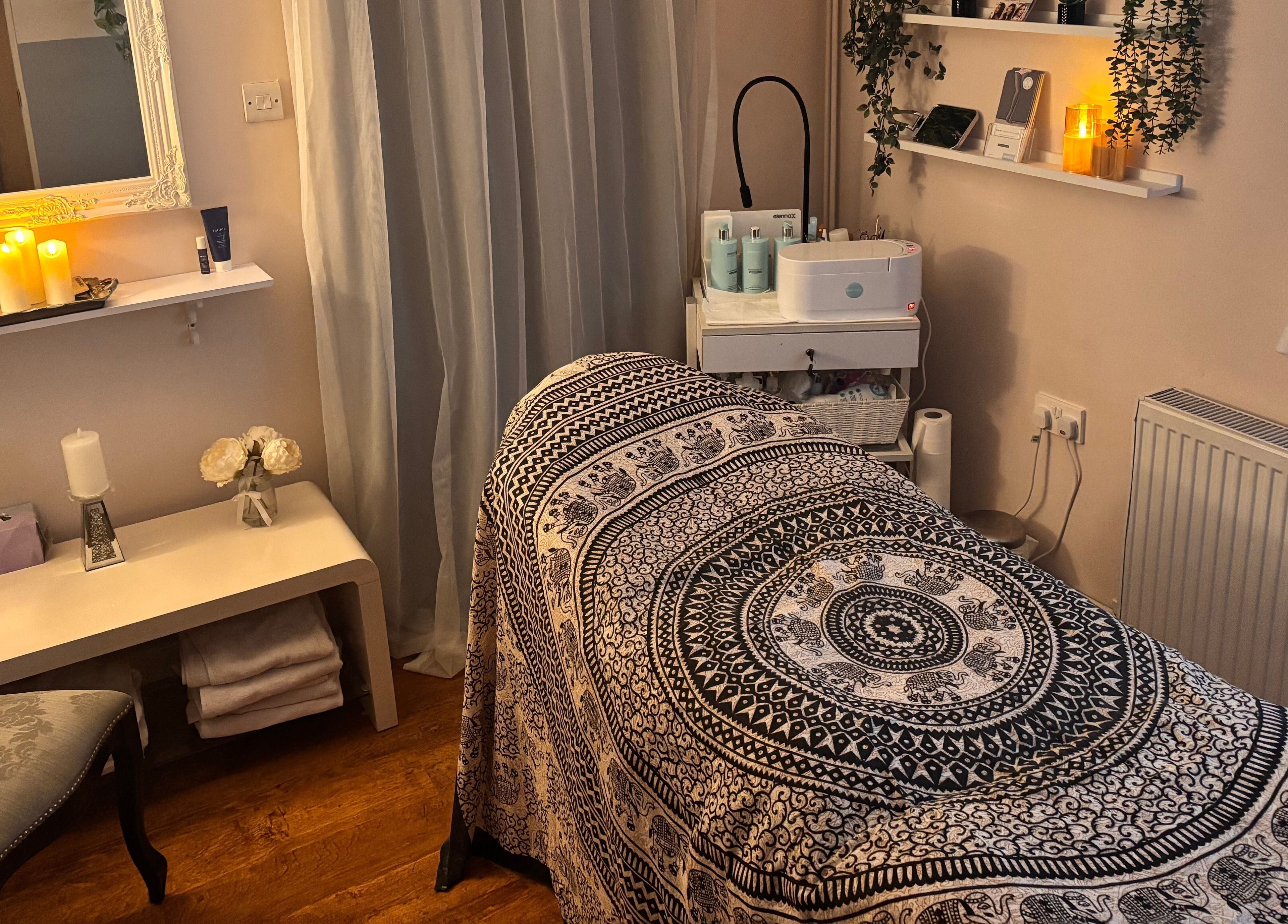 Relaxing treatment room at Elegance Beauty, Osmaston, England, GB with ambient lighting and soothing decor.
