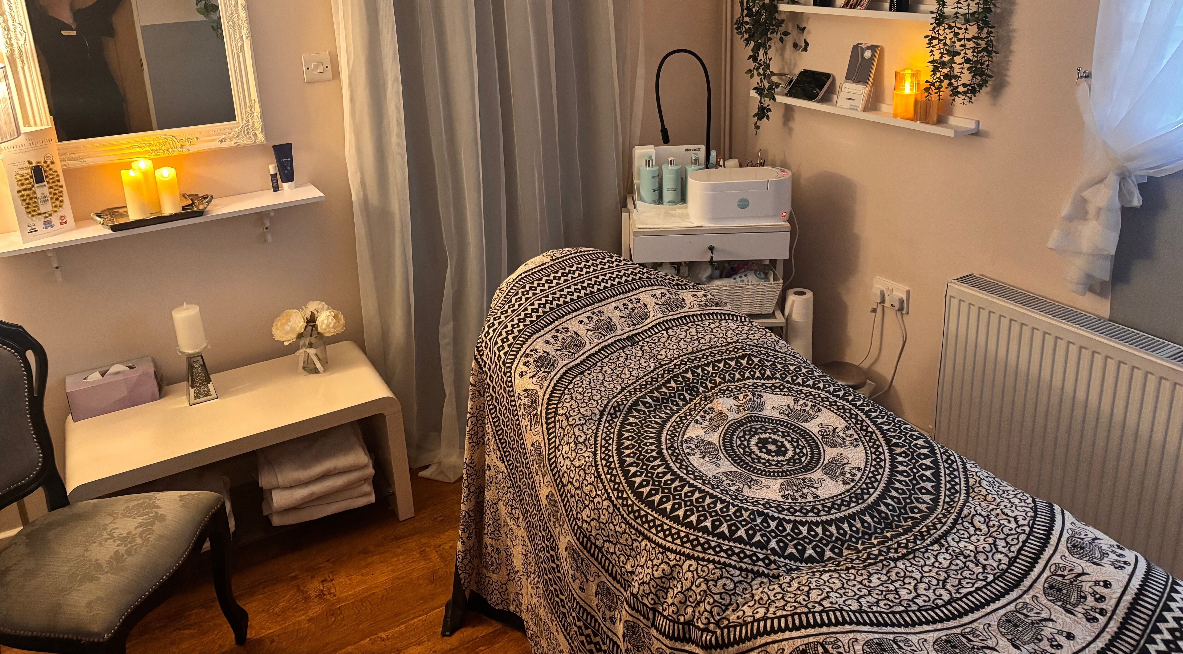 Relaxing treatment room at Elegance Beauty, Osmaston, England, GB with ambient lighting and soothing decor.