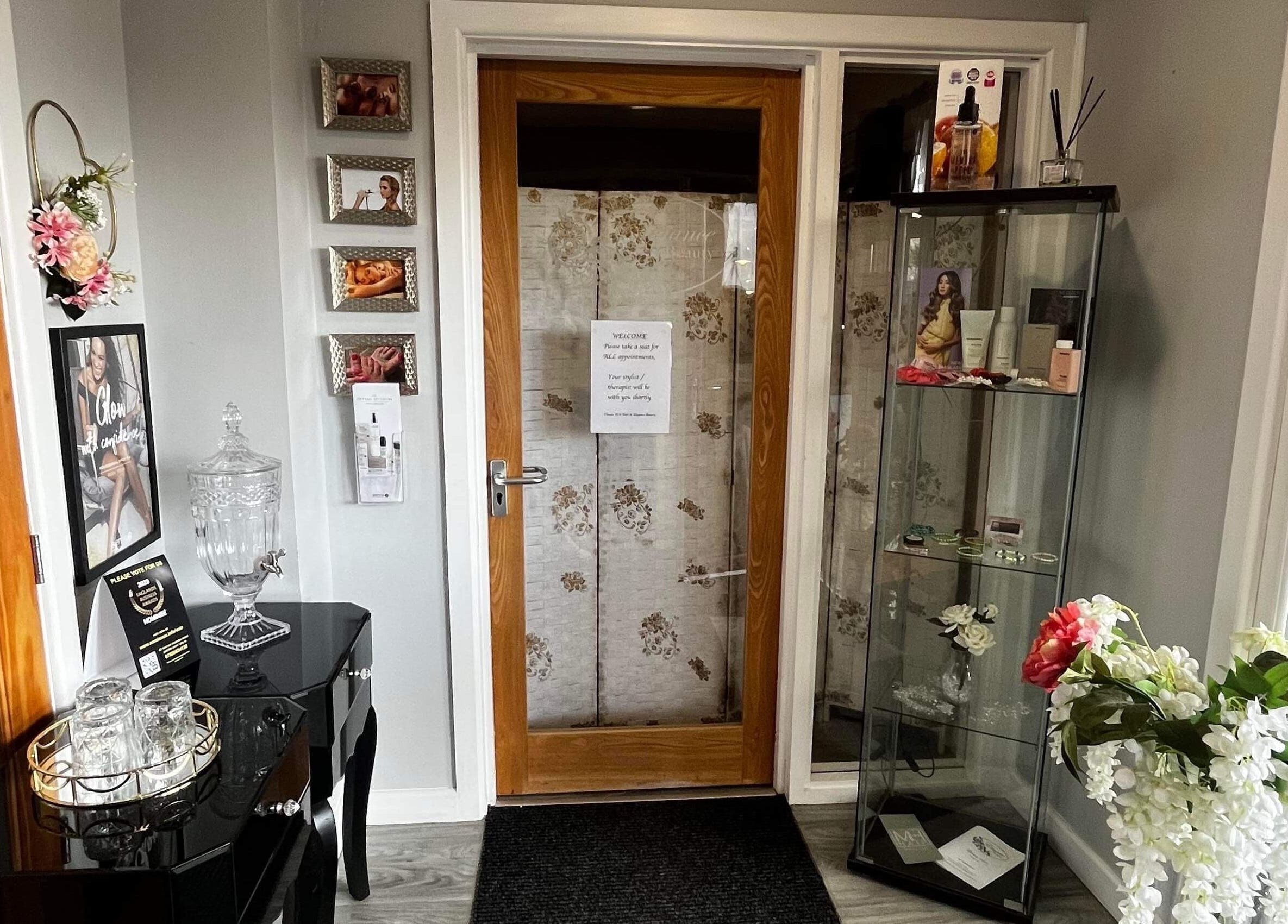 Stylish entrance of Elegance Beauty in Osmaston, England, featuring floral decor and chic displays.