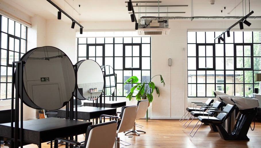 Bright, modern salon interior at Studio 90, London, England, GB with chic design and stylish seating.