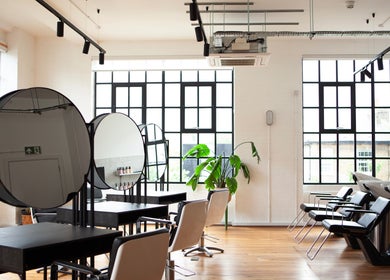 Bright, modern salon interior at Studio 90, London, England, GB with chic design and stylish seating.