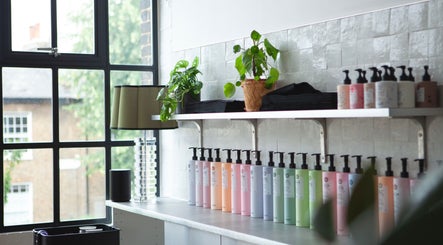 Elegant beauty product display on a shelf at Studio 90, London, England, GB with plants and chic decor.
