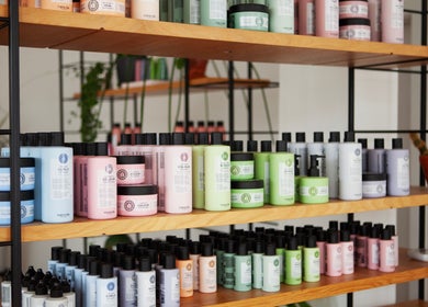 Vibrant haircare products on shelves at Studio 90, London, England, GB, showcasing diverse beauty essentials.