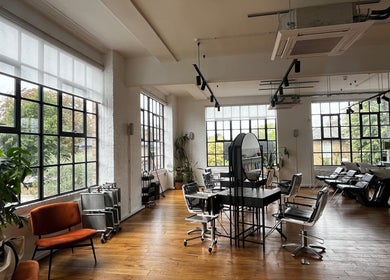 Spacious interior of Studio 90, a chic beauty venue in London, England, GB with modern decor and natural light.